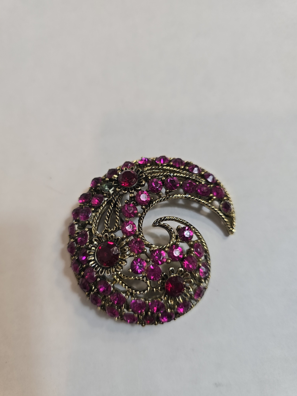 Gold-Tone Swirl Brooch with Vibrant Fuchsia Stones